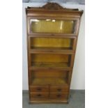 A turn of the century medium oak Globe-Wernicke style five-section stacking bookcase, with carved