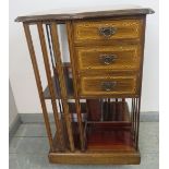 An Edwardian mahogany revolving bookcase, featuring parquetry inlay, with three short drawers and an