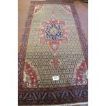 A superb Persian carpet, central motif on a latticework ground with quarter spandrels. 317cm x