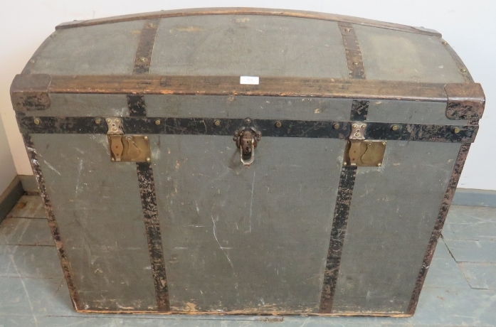 A large antique dome topped metal bound travelling trunk by Moritz Madler of Leipzig, on small brass