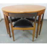 A mid-century Danish teak dining set by Frem Rojle, the table with butterfly-leaf extension, on