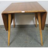 A mid-century ‘Windsor’ elm and beech drop-leaf dining table, on canted supports. H71cm W61-136cm