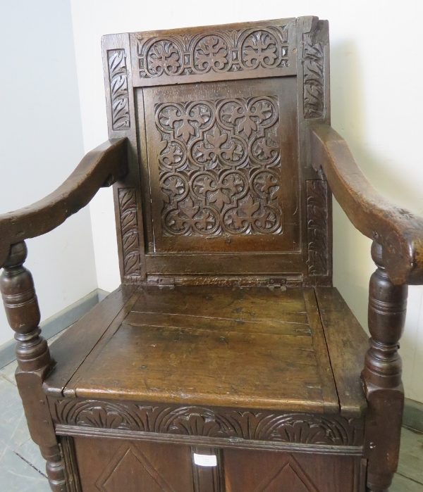 A 17th century and later oak wainscot chair, with relief carved panel back, above a box base with - Image 2 of 3