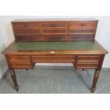 A 19th century French rosewood writing desk, the upper gallery housing six short drawers, over a
