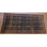 North East Persian Zabul Belouch rug, central panel in reds on blue ground within geometric