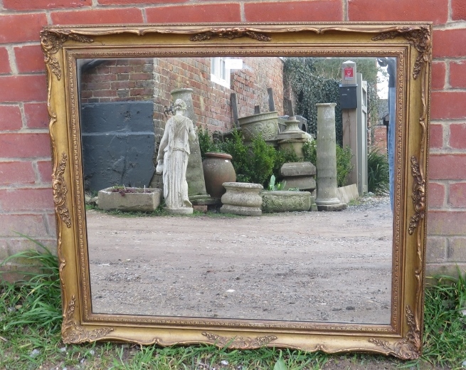 A 19th century style rectangular wall mirror in moulded gilt gesso frame. H78cm W88cm D5cm (approx).