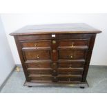A 17th century and later oak chest housing five graduated drawers with geometric moulding and