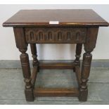 A reproduction oak joint stool in a 16th century taste, with chip carved frieze, on turned