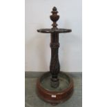 A good quality Victorian mahogany stick stand, the centre finial carved with a Chimera, above four