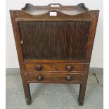 A Georgian mahogany bedside cabinet, with shaped gallery, above a cupboard with tambour door and