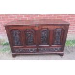 An 18th century oak mule chest, the front with fielded panels featuring relief carved woodland