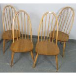 A set of four mid-century ‘Windsor Quaker’ elm and beech blonde dining chairs by Ercol, on canted