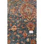 A fine Persian Kashan carpet, central terracotta motif on blue ground. 420cm x 290cm. Condition