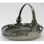 Archibald Knox ‘Tudric’ for Liberty swing handled pewter basket, circa 1905. Of oval form, decorated