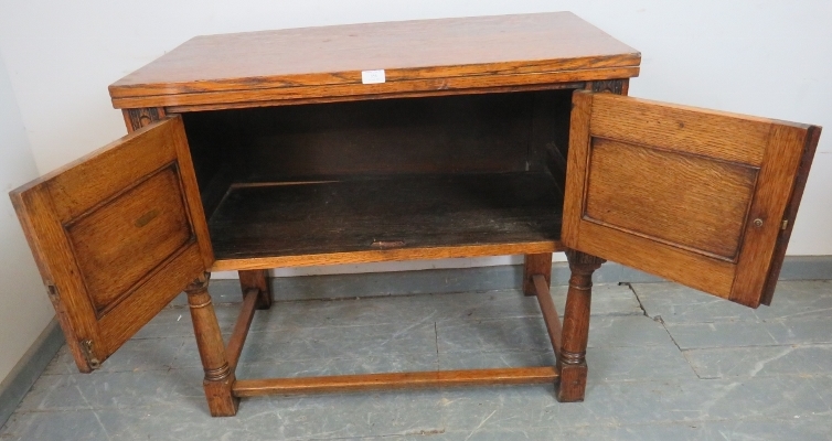 A reproduction medium oak side cabinet, with relief carving in the 17th century taste, on tapering - Image 3 of 3