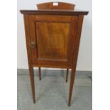 An Edwardian mahogany bedside cabinet featuring crossbanded inlay, with loose shelf, on tapering