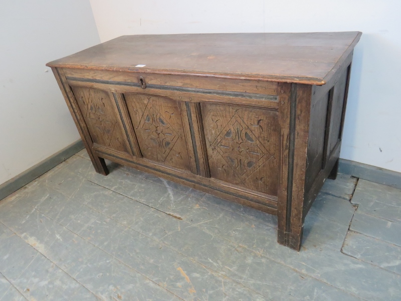 An early 18th century panelled oak coffer, with diamond carved front, on stile supports. H66cm - Image 2 of 3