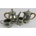 Liberty and Co, English pewter 4 piece tea set, 1372. Hammered surface. Raffia handle to tea pot.