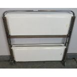 A mid-century Italian white melamine and chrome two-tier folding drinks trolley, on castors. H84cm