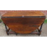 A late 17th/early 18th century oak oval gate-leg table of good colour, with single drawer, on barley