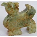 A Chinese carved celadon and russet Jade Phoenix, Ming style but likely Qing, 8cm high x 9cm long.