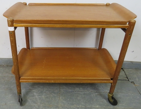 A mid-century teak two-tier drinks trolley, with two removable trays, on castors. H62cm W74cm