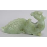 A Chinese carved pale celadon Phoenix, Ming style but likely Qing, 16cm long x 8cm high. Provenance: