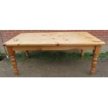 A Victorian style stripped pine kitchen table, on baluster turned tapering supports. H77cm W182cm