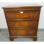 A reproduction mahogany bachelor’s chest, crossbanded and strung with satinwood and ebony, with