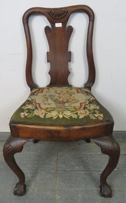 An antique occasional chair in the manner of George II, with shaped back splat and drop-in