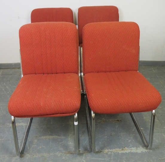 A set of four mid-century chairs, upholstered in burnt orange striped material, on tubular chrome