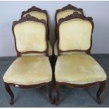 A set of four 19th century French dining chairs, the ornately carved cornices with acanthus scrolls,