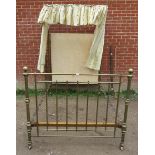 A Victorian brass double bed, with ball finials and crown canopy featuring patterned silk drapes and