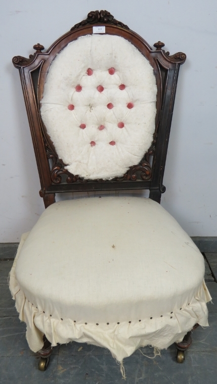 A Victorian mahogany bedroom chair, with fluted bun finials and acanthus carved and pierced back, on