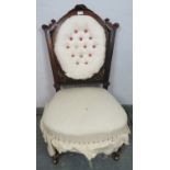 A Victorian mahogany bedroom chair, with fluted bun finials and acanthus carved and pierced back, on
