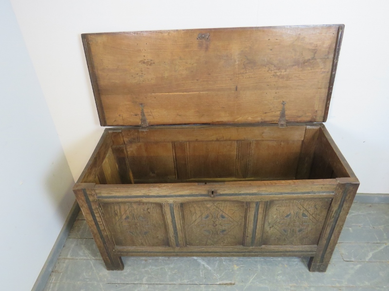 An early 18th century panelled oak coffer, with diamond carved front, on stile supports. H66cm - Image 3 of 3