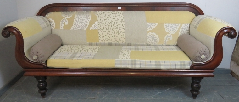 A Victorian mahogany show-wood sofa, with scrolled arms, reupholstered in contemporary patchwork