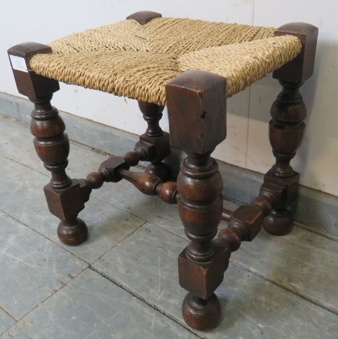 A small vintage oak stool with braided rope seat, on cup and cover supports united by a turned and - Image 2 of 3