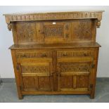 A vintage medium oak court cupboard in the 16th century taste, with chip carved frieze and