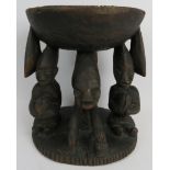 Tribal Art: A Kola nut carved wood offering stand, Yoruba Tribe. Carved depicting three figures