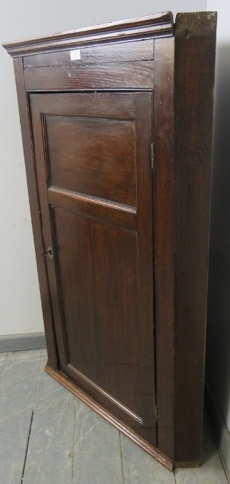 A Georgian oak wall-hanging corner cupboard, the panelled door opening onto three shaped shelves. - Image 2 of 3