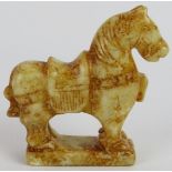 A Chinese carved russet Jade standing horse, with saddle, on plinth base, Ming style but likely