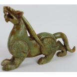 A Chinese carved celadon and russet Jade prowling Bixie, Ming style but likely Qing, 18cm long x