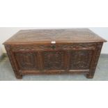 A late 17th/early 18th century panelled oak coffer, with relief carving to lid and front panels,