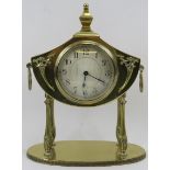 A brass twin handled mantle clock, early 20th century. With Neoclassical elements. Key and
