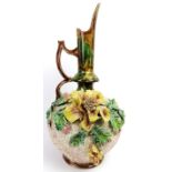 A large majolica ewer, 19th century. Decorated with flowers and foliage applied in high relief.