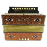 A Hohner melodeon, circa 1940s. Modelled with a simulated burr walnut exterior. 7.3 in (18.5 cm)