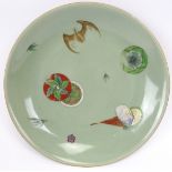 A rare Chinese enamel decorated celadon dish, 19th century. Decorated in overglaze enamels with a