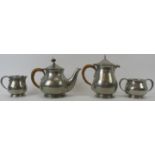 Liberty and Co, English pewter 4 piece tea set, 1372. Hammered surface. Raffia handle to tea pot.