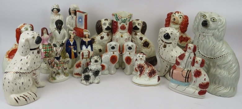 A large group of Staffordshire ceramic figures. Comprising a wide variety of King Charles Spaniels